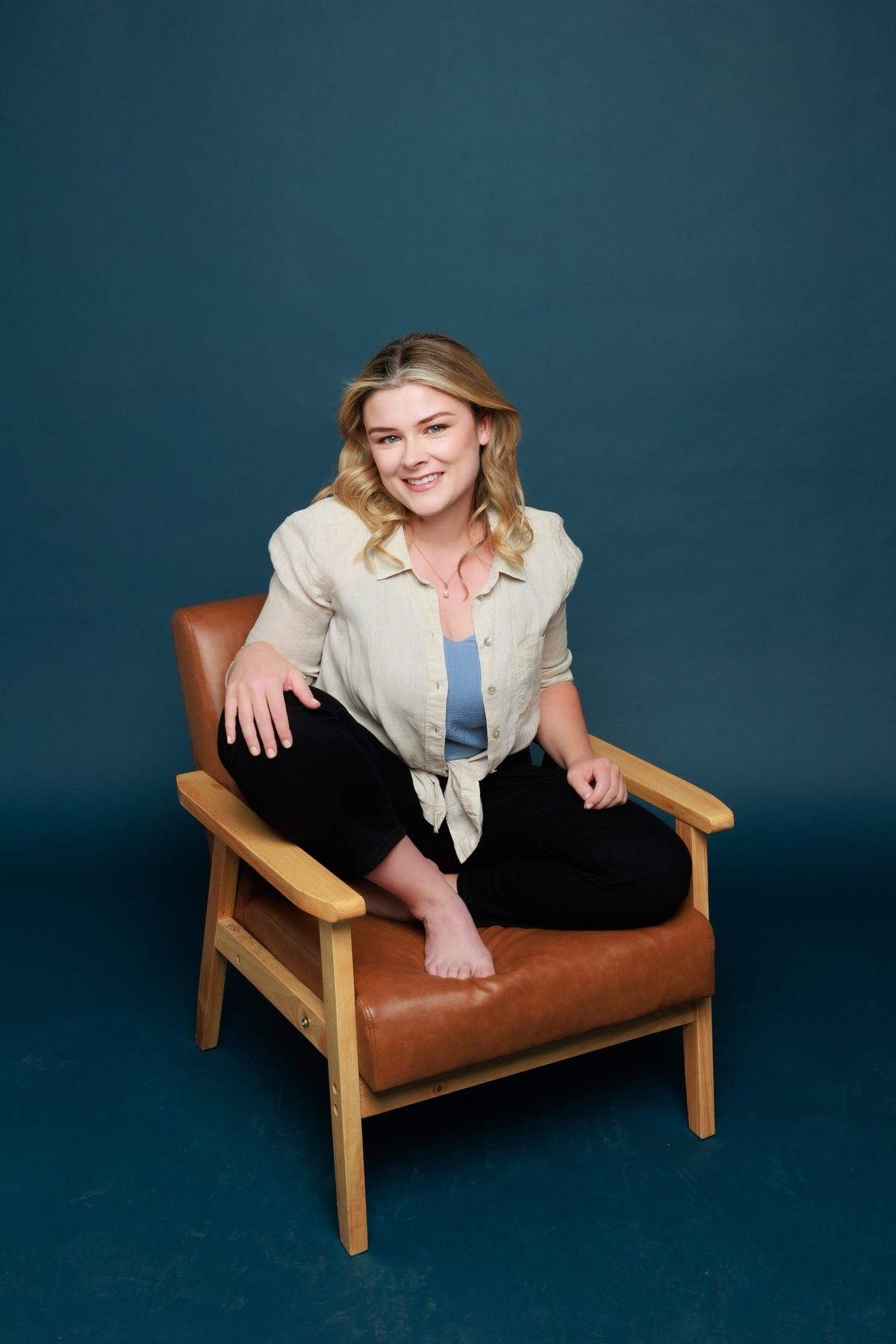 Louise Griffiths sitting in a leather armchair